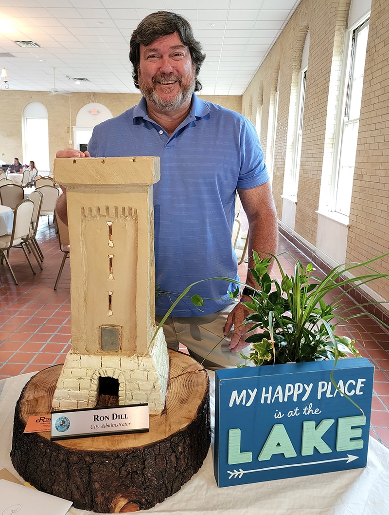 Ron Dill stands with a wooden model of the Fort Thomas Tower.