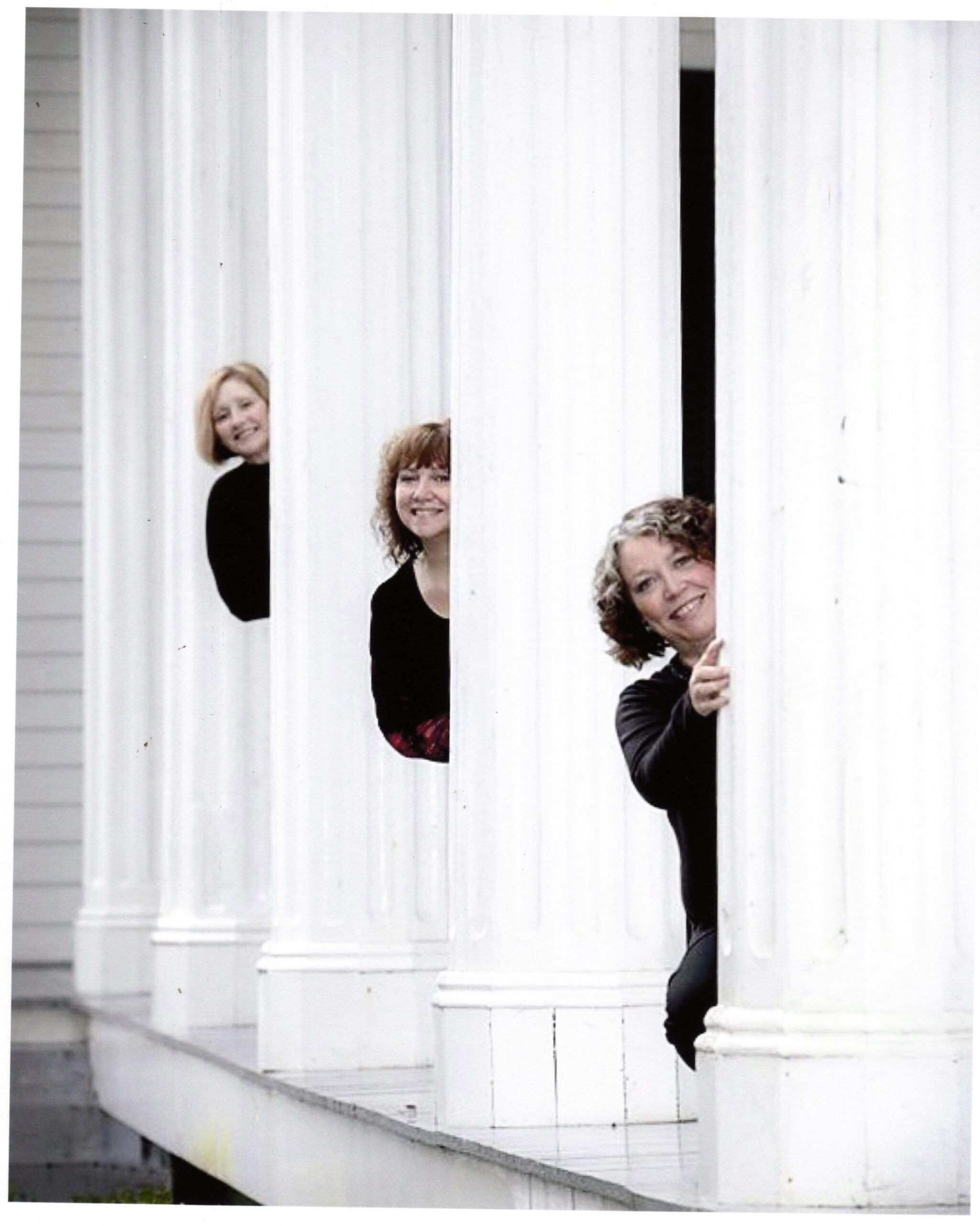 Three women behind columns