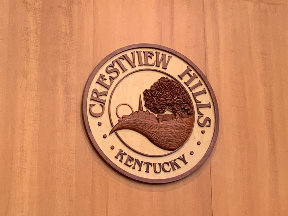 The crest of the city of Crestview Hills sits above the city council bench.