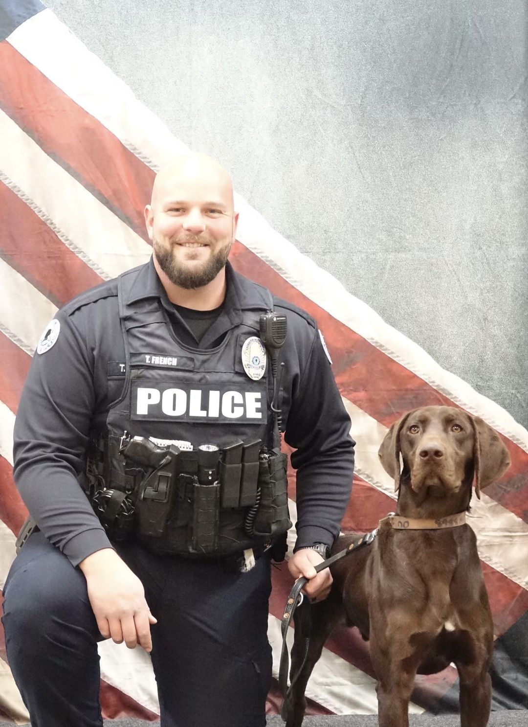 Police officer with police dog, a German short hair pointer.