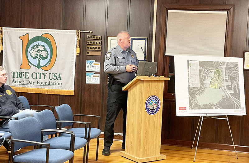 Man in police uniform at a lectern.