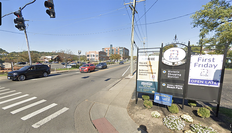 Busy intersection with cars. There is a sign for Bellevue Kentucky.